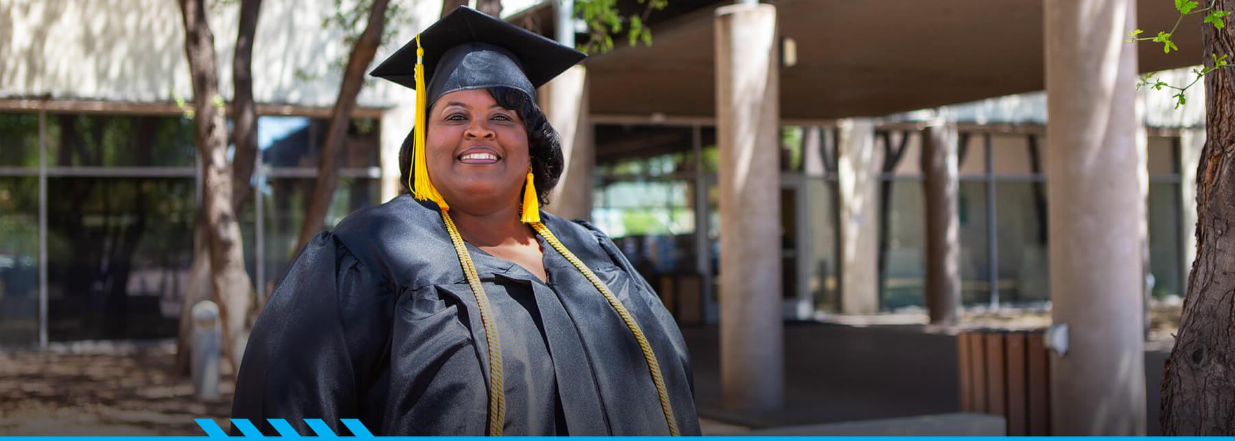 Stacie Williams poses for the camera in her graduation cap and gown.